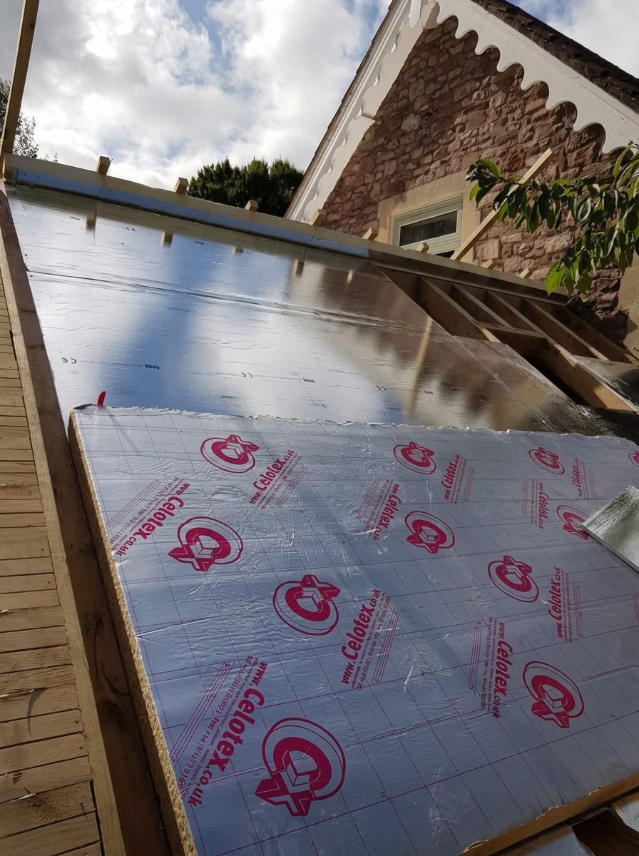 Insulation being laid on a timber deck during a flat roof replacement in Bath